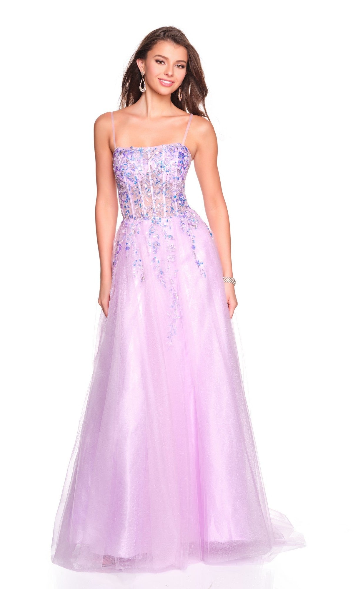 A woman in the Long Prom Dress: Dave and Johnny 12762, a sleeveless, floor-length lavender gown with floral embellished bodice and tulle A-line skirt, smiles against a white background.